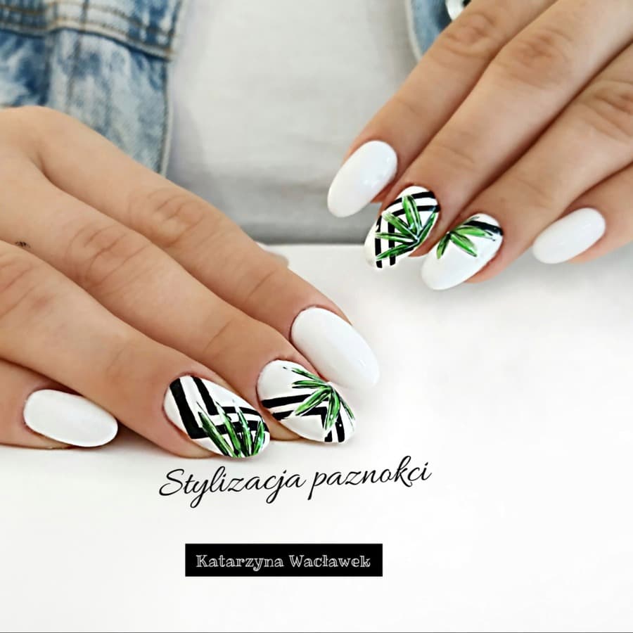 Manicure żelowy - białe owalne paznokcie z liściastymi wzorami